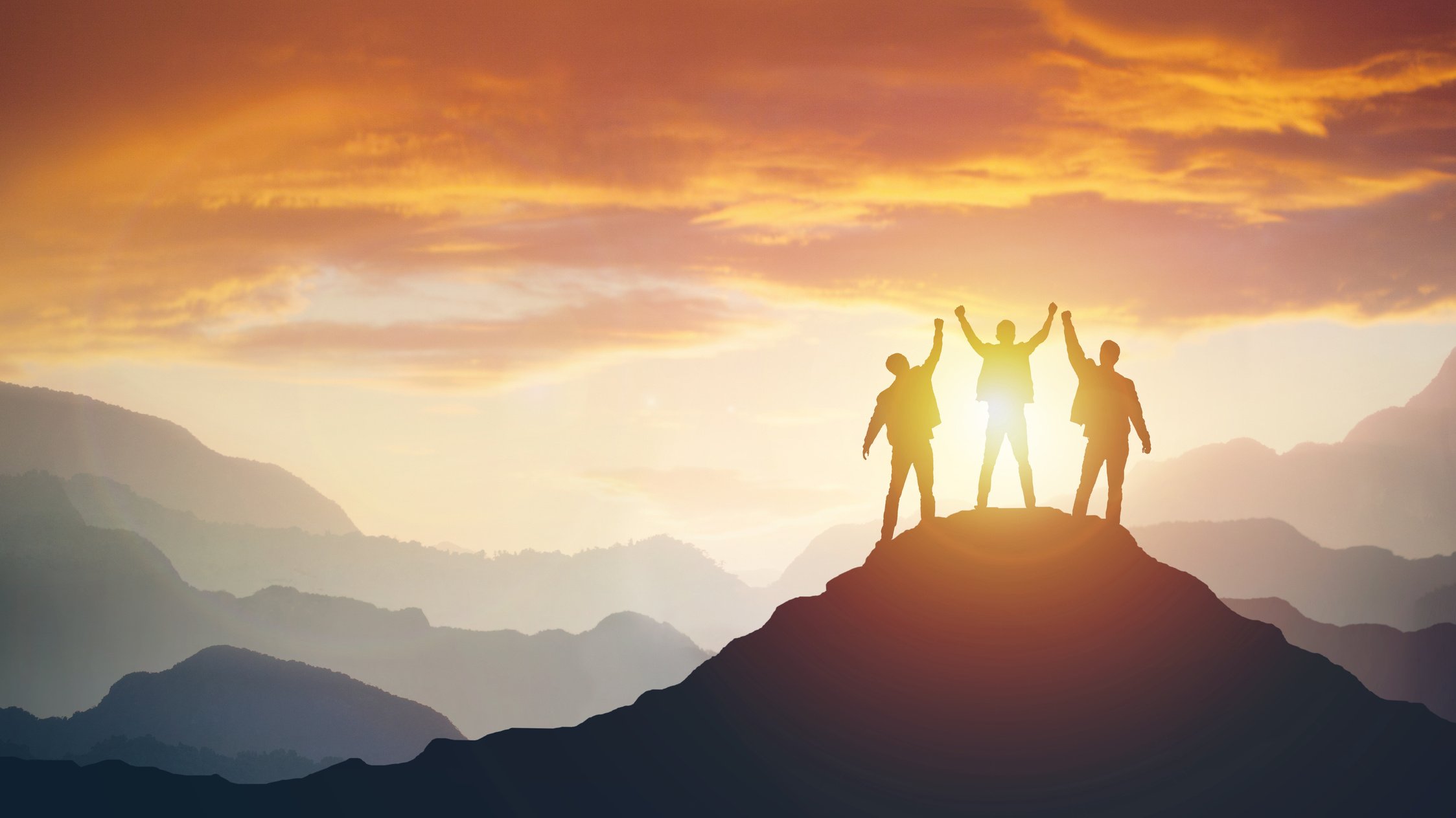 Group of peoples on mountains top in winner pose